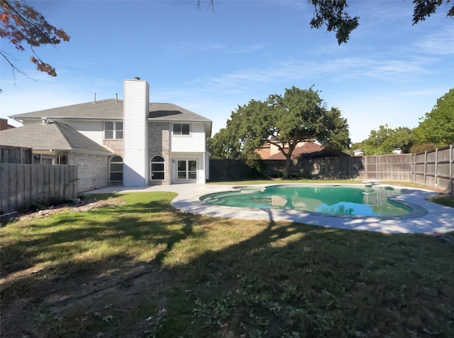 view of pool with a lawn and a diving board