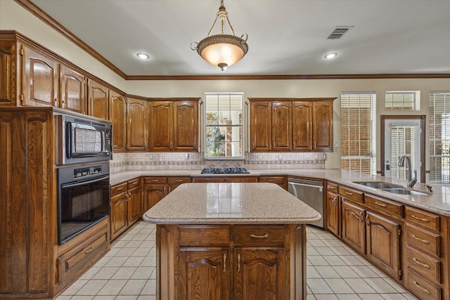 kitchen featuring pendant lighting, sink, tasteful backsplash, a kitchen island, and black appliances