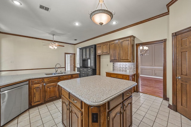 kitchen featuring a kitchen island, tasteful backsplash, sink, light tile patterned flooring, and stainless steel dishwasher