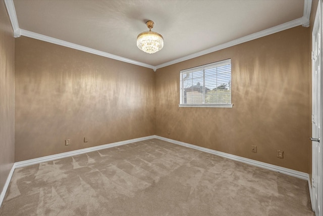 carpeted spare room featuring ornamental molding and an inviting chandelier