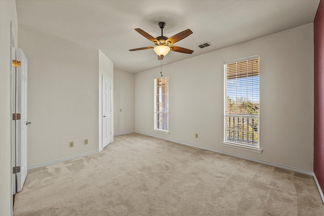 empty room featuring light carpet and ceiling fan