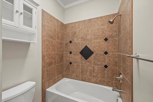 bathroom featuring toilet, tiled shower / bath, and crown molding