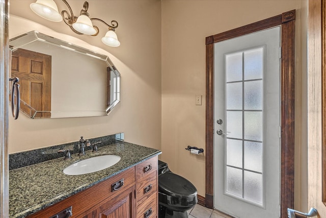 bathroom with vanity, toilet, and tile patterned flooring