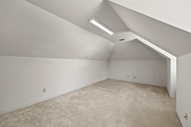 bonus room featuring light colored carpet and lofted ceiling