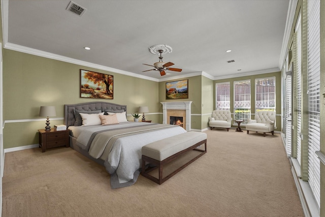 carpeted bedroom featuring ceiling fan and ornamental molding