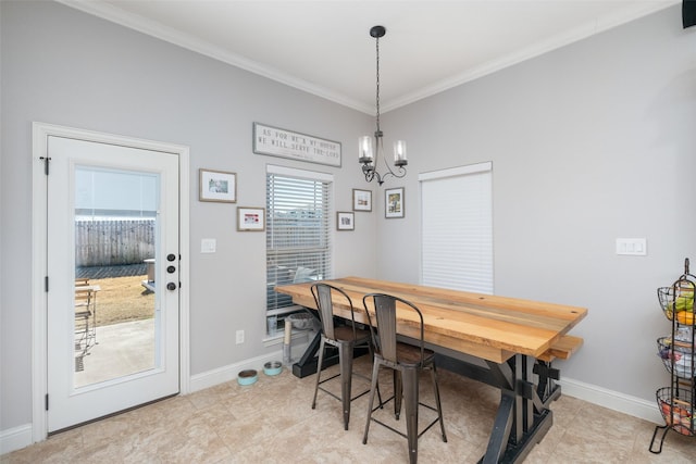 dining space with crown molding and a notable chandelier