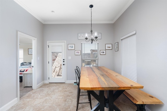 dining room with ornamental molding and a notable chandelier