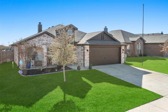 view of front of property featuring a garage and a front lawn