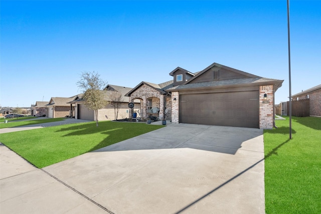 ranch-style home featuring a garage and a front lawn