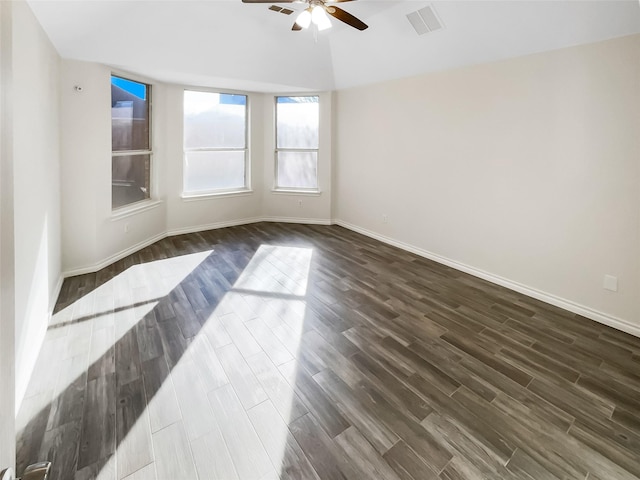 unfurnished room with ceiling fan and dark hardwood / wood-style floors