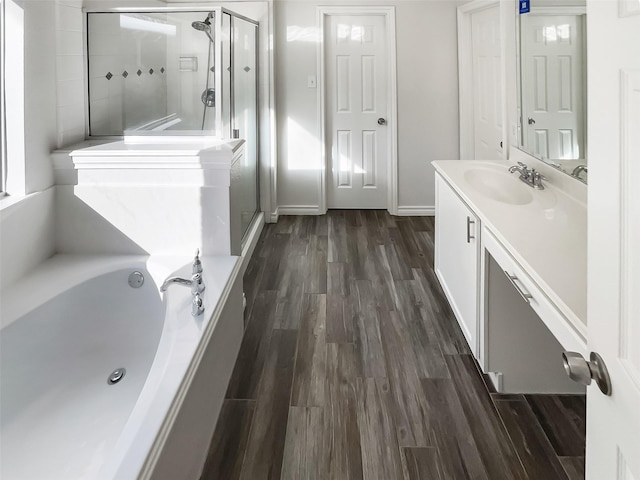 bathroom featuring vanity, hardwood / wood-style floors, and separate shower and tub