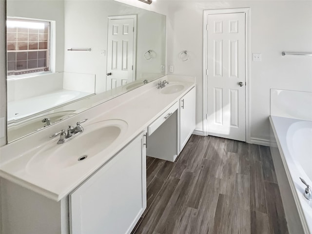 bathroom featuring vanity, a bathtub, and hardwood / wood-style floors