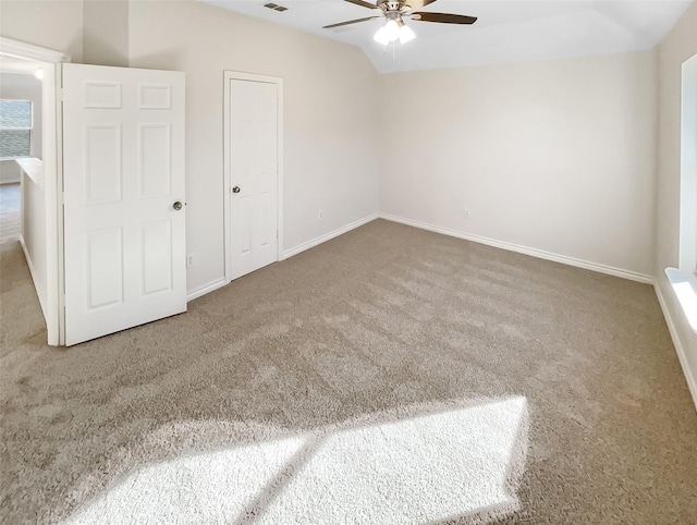 unfurnished bedroom with ceiling fan, carpet, and vaulted ceiling