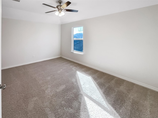 spare room featuring ceiling fan and carpet flooring