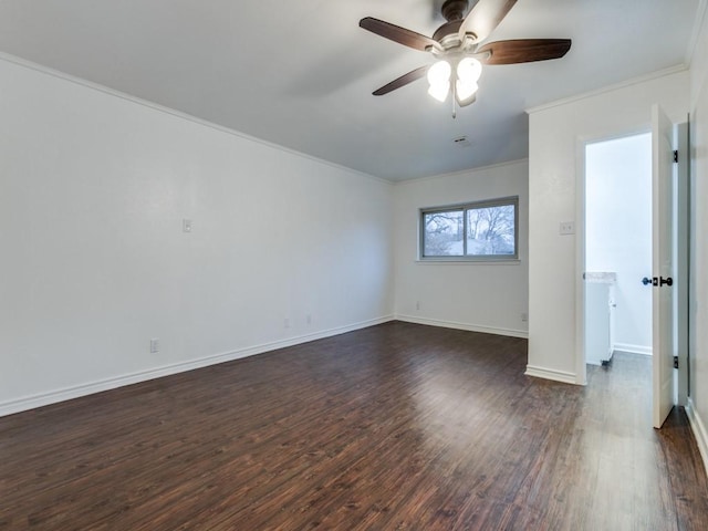 spare room featuring ornamental molding, dark wood-type flooring, and ceiling fan