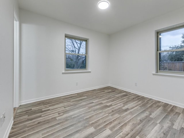 unfurnished room with light wood-type flooring