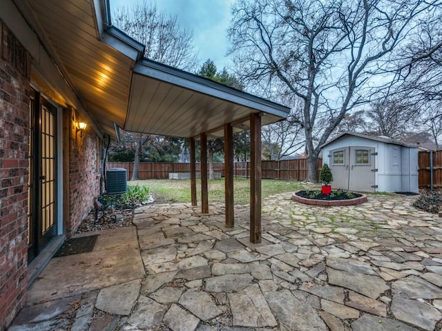 view of patio featuring a shed and central air condition unit