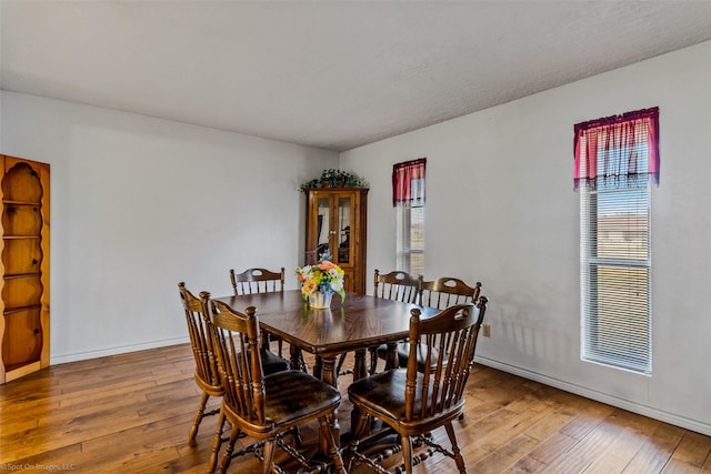 dining space with hardwood / wood-style flooring