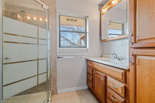 bathroom featuring vanity, a healthy amount of sunlight, and an enclosed shower