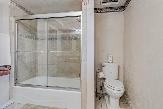 bathroom with toilet, enclosed tub / shower combo, and tile patterned flooring