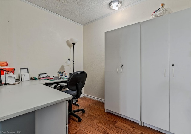 office area featuring dark wood-type flooring, a textured ceiling, and ornamental molding