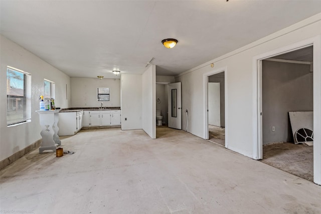 interior space with white cabinets and sink