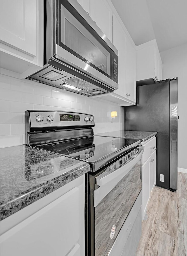 kitchen with white cabinets, light hardwood / wood-style flooring, and stainless steel appliances