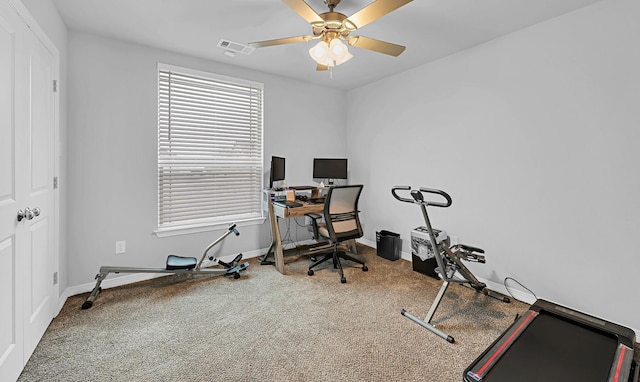 workout room featuring ceiling fan and carpet