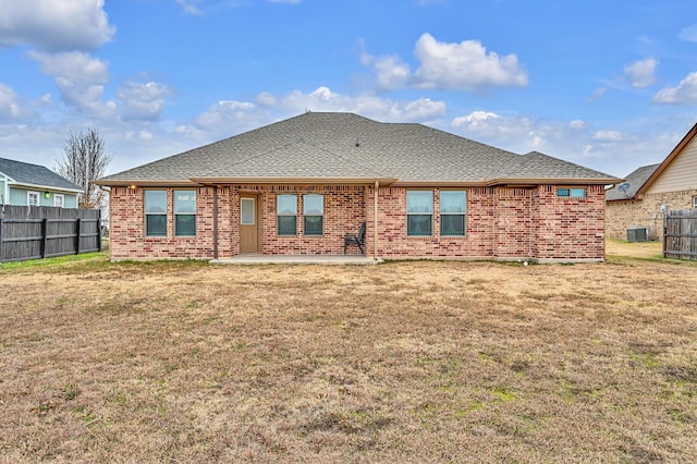 rear view of house with a patio area, a yard, and central AC unit