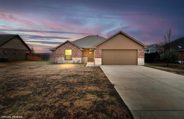 view of front of property featuring cooling unit, a yard, and a garage