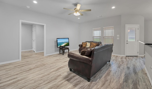 living room featuring light hardwood / wood-style floors and ceiling fan