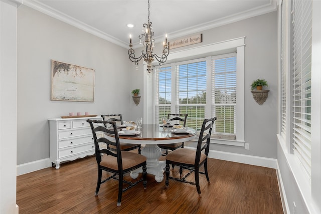 dining area featuring crown molding, dark wood-type flooring, and an inviting chandelier