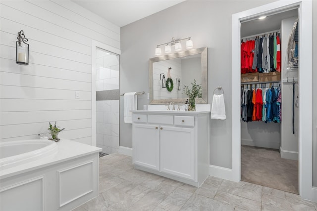 bathroom with vanity, a shower, and wood walls