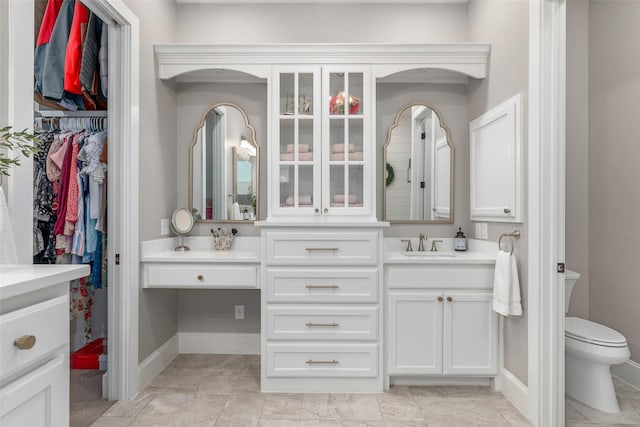 bathroom featuring tile patterned flooring, vanity, and toilet