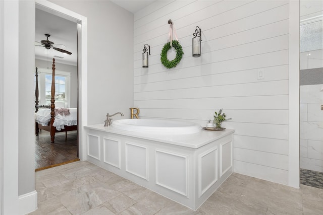 bathroom with crown molding, ceiling fan, and a bathtub