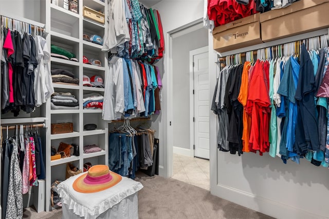 walk in closet featuring carpet flooring