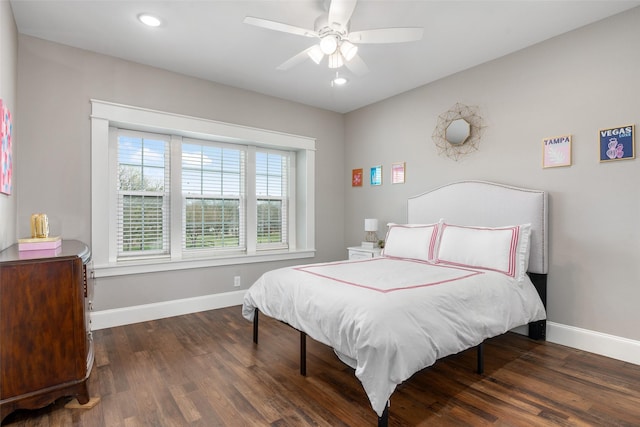 bedroom with dark hardwood / wood-style floors and ceiling fan