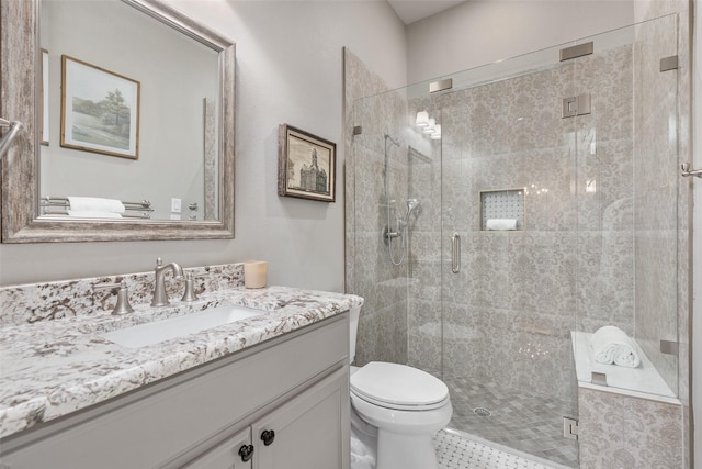 bathroom featuring an enclosed shower, vanity, and toilet