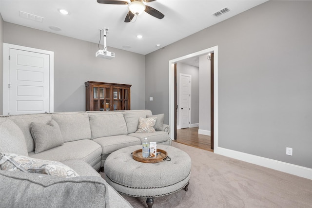 living room with ceiling fan and carpet flooring