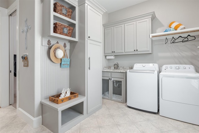 washroom featuring washer and clothes dryer and cabinets