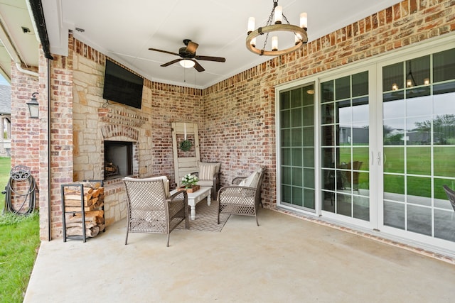 view of patio with ceiling fan and an outdoor stone fireplace