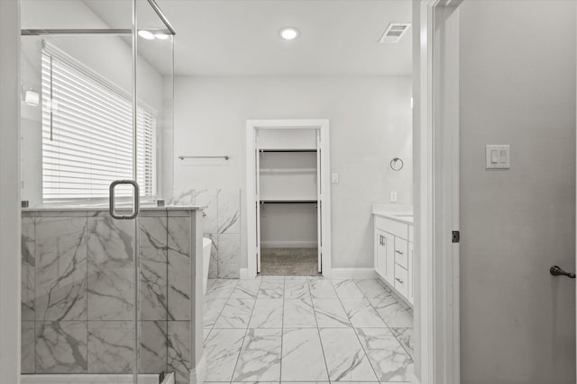 bathroom with walk in shower and vanity