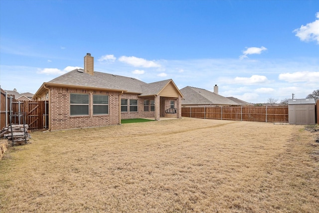 back of house featuring a lawn and a storage unit