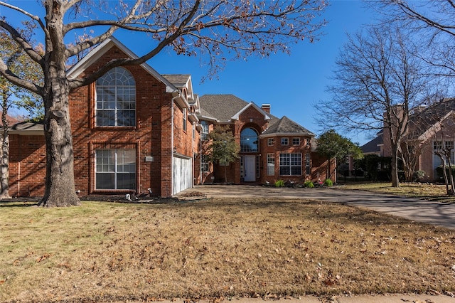 view of property with a garage and a front yard