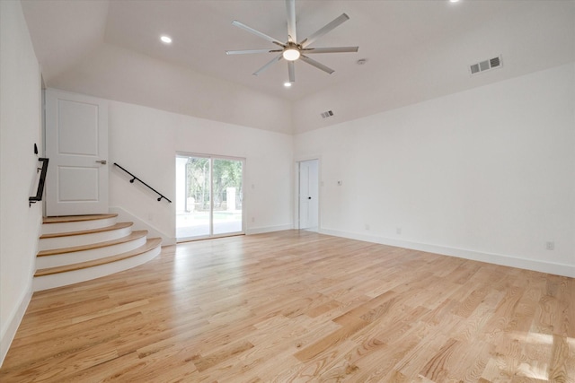 unfurnished living room with light hardwood / wood-style floors, high vaulted ceiling, and ceiling fan