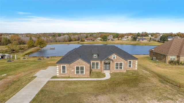 view of front of property with a front yard and a water view