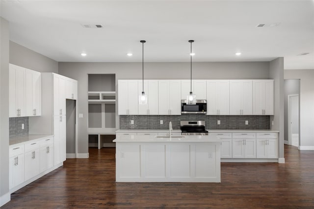 kitchen featuring sink, pendant lighting, white cabinets, and stainless steel appliances