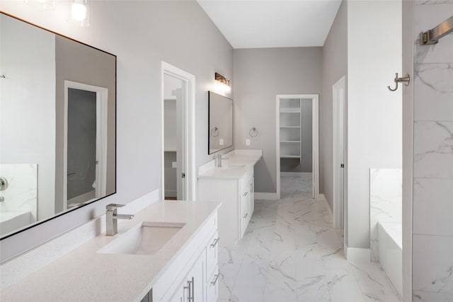 kitchen featuring pendant lighting, white cabinets, stainless steel appliances, an island with sink, and sink