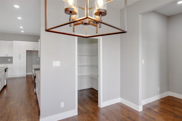 interior space featuring dark hardwood / wood-style flooring and a chandelier