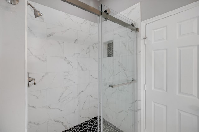 bathroom featuring a shower with shower door